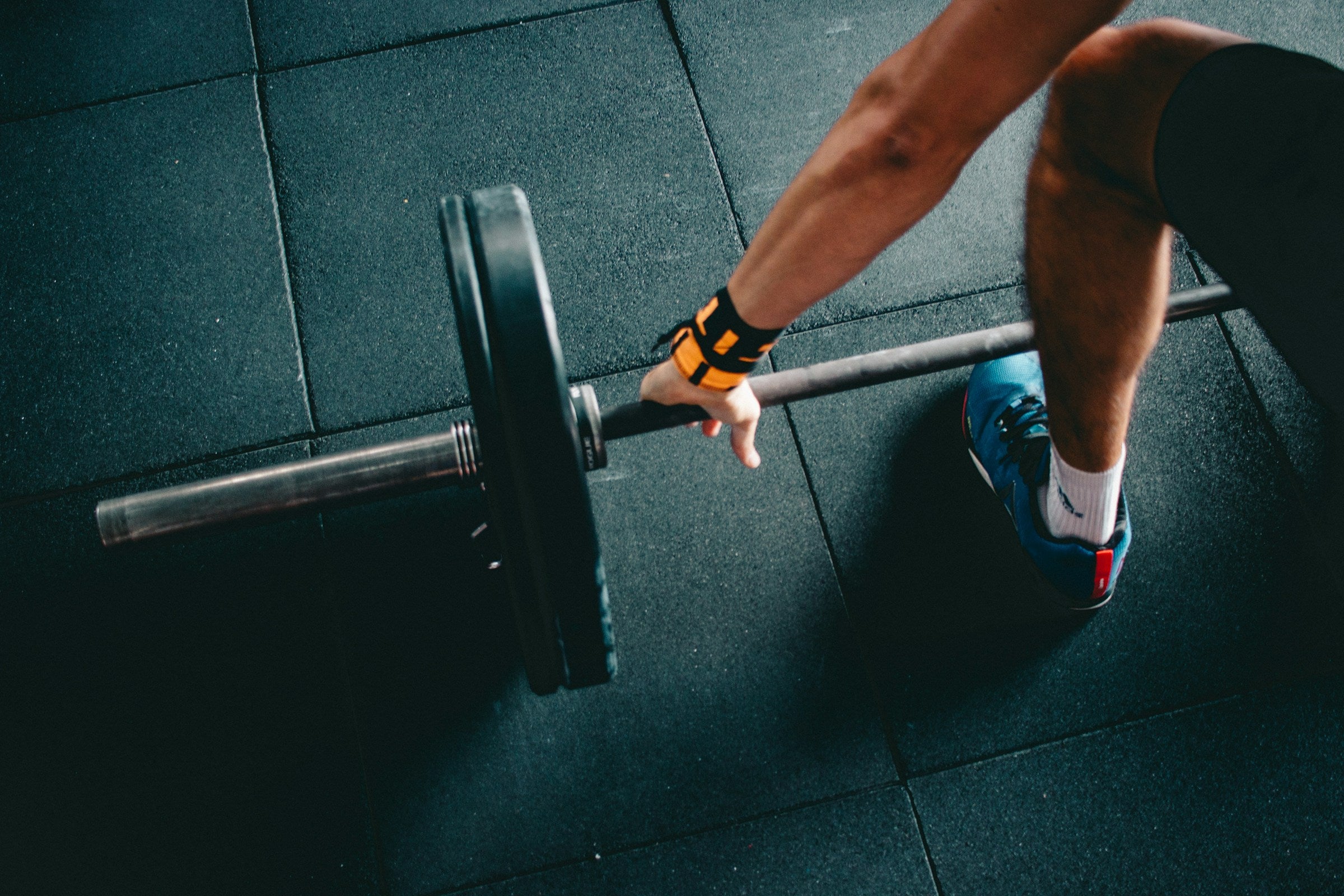 Athlete lifting a barbell mid-workout